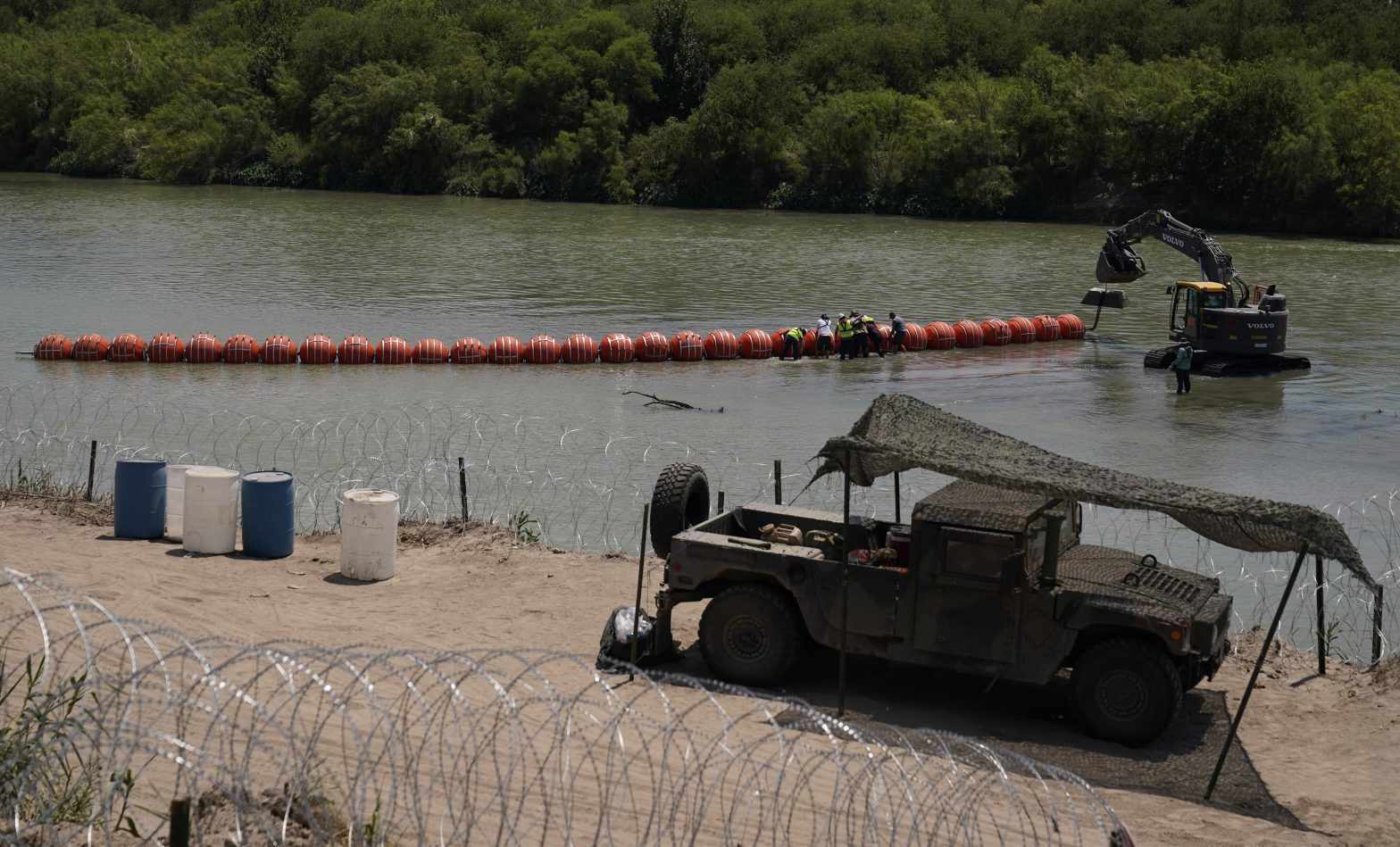 Biden Administration Sues Abbott Over Rio Grande Buoy Barrier Meant to Stop Migrants